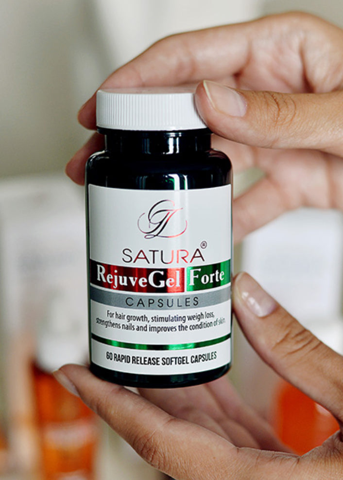 Hands holding Satura RejuveGel Forte capsules bottle for hair growth, weight loss, and skin health