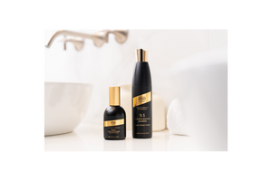 DSD De Luxe black and gold bottles of hair care products on a white bathroom countertop